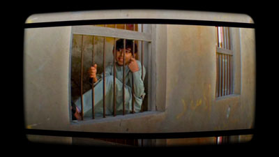 φωτογραφία απο απόσπασμα video / παιδί πίσω από κάγκελα σπιτιού