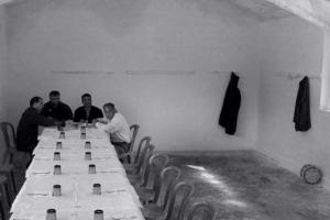 φωτογραφία: Βασίλης Αρτίκος / άνδρες κάθονται σε ένα μακρύ τραπέζι σε εσωτερικό χώρο