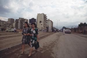 γυναίκες περπατάνε αγκαζέ σε χωματόδρομο πόλης / Αναζήτηση_Λίβανος